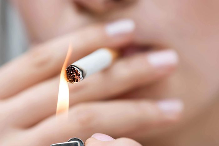 woman lighting cigarette