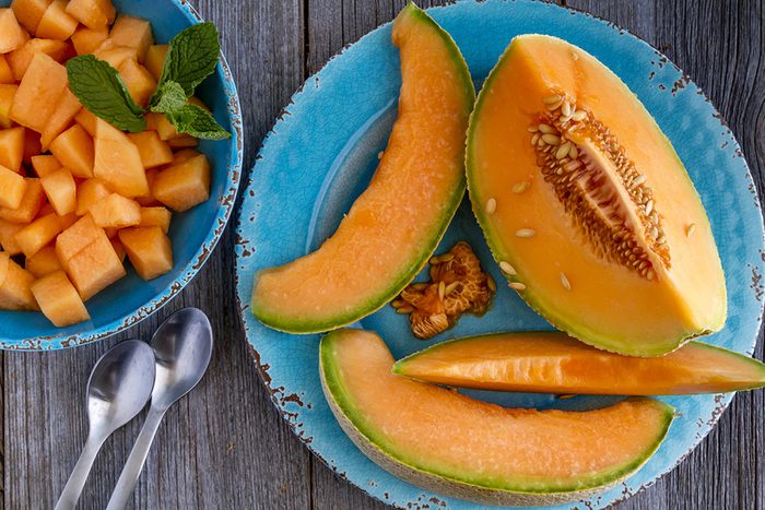 cantaloupe slices on a plate and chunks in a bowl