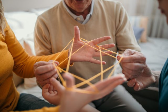 family playing cats cradle