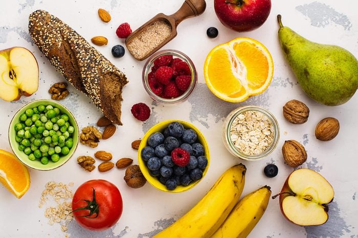 Colorful fruits, nuts, legumes, bread and other fiber-filled foods