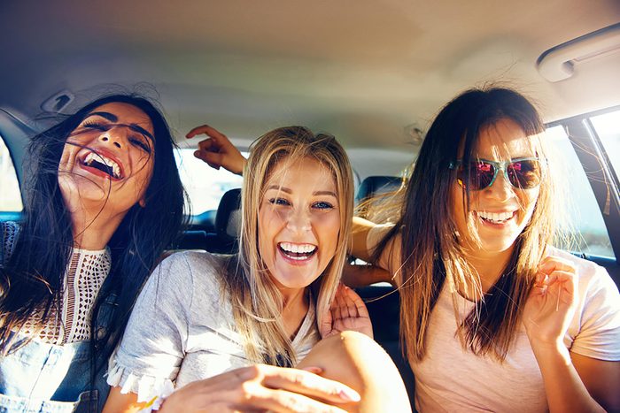 3 women in a car laughing
