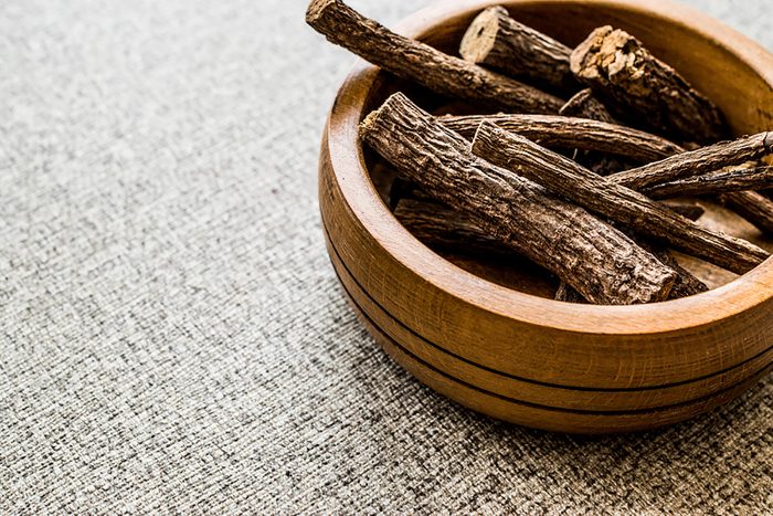 pieces of Licorice root in a wooden bowl
