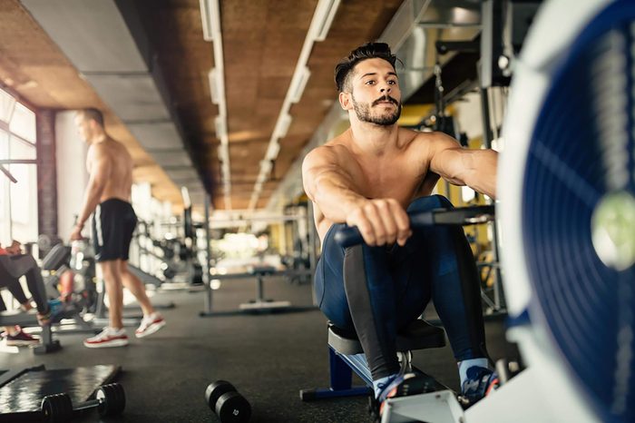 shirtless men working out in a gym
