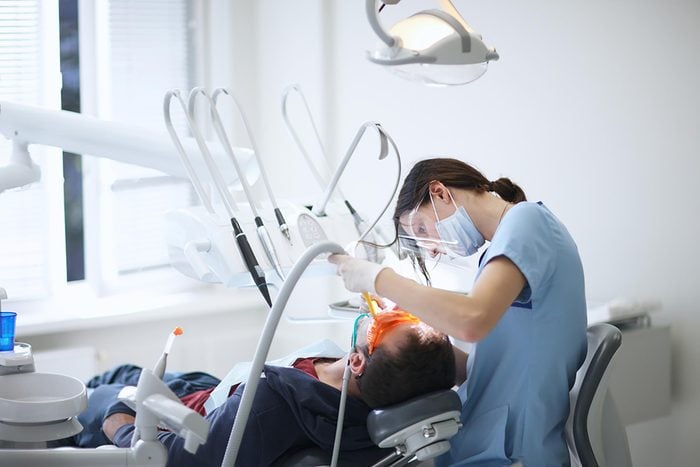 Dentist working on a patient in a dental chair