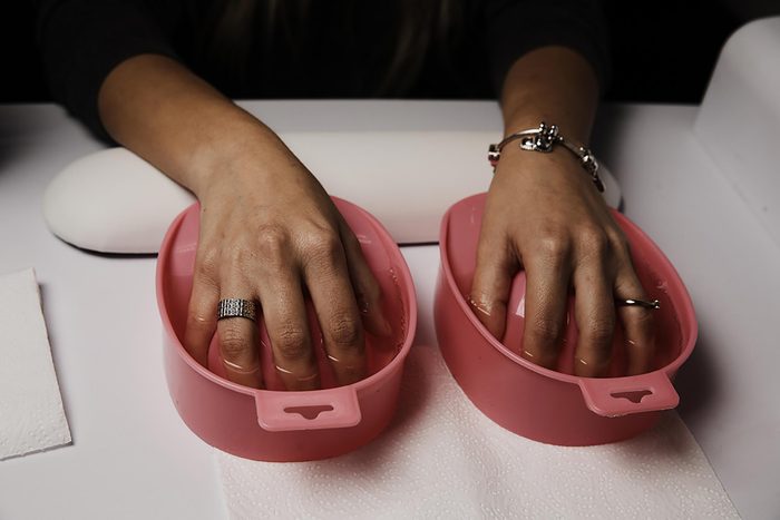 black woman soaking nails during a manicure