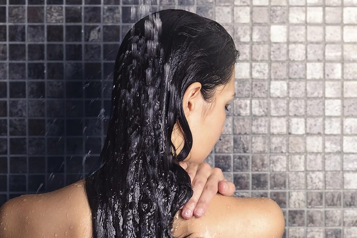 Woman in shower with wet hair