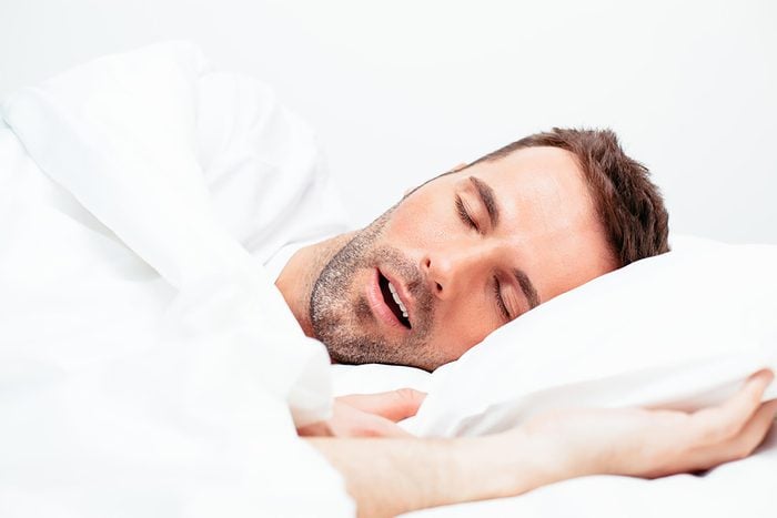 man on his side sleeping with his mouth open