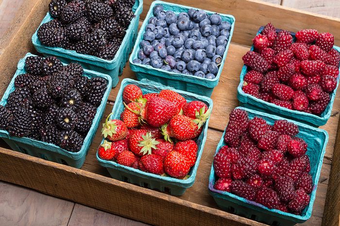 different types of berries in baskets 