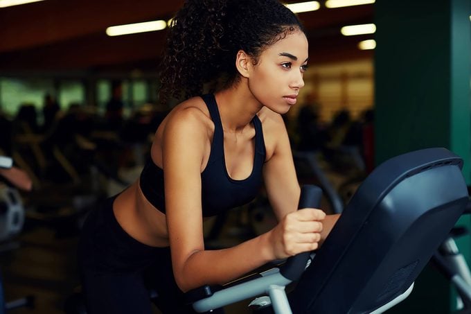 woman at gym on exercise machine