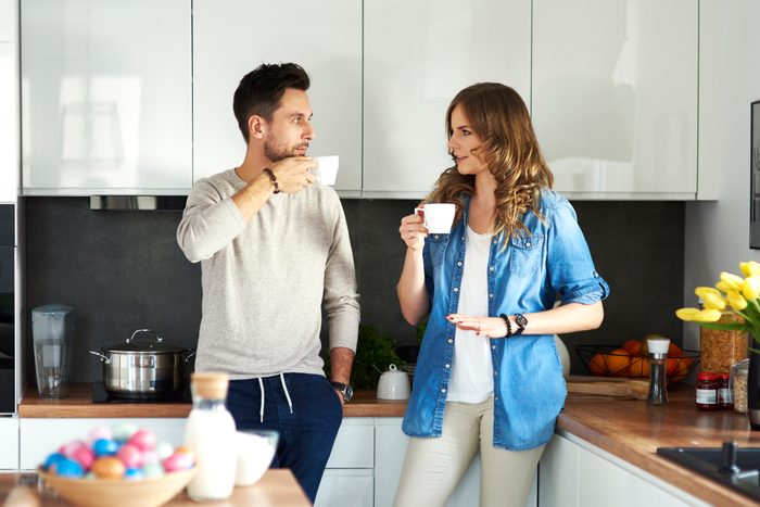 couple talking to each other in kitchen