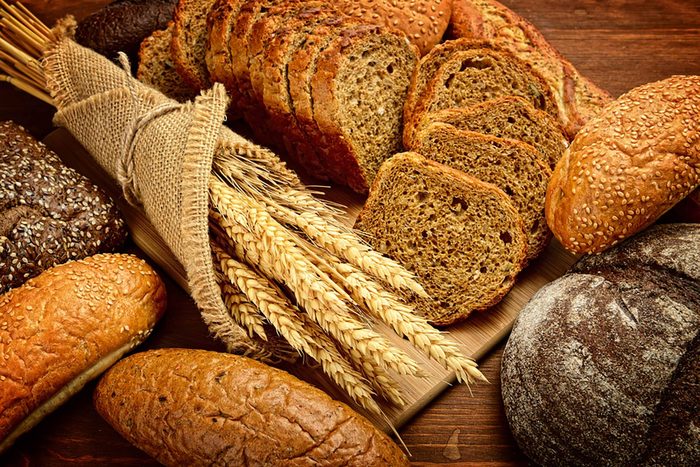 collection of whole grain breads and wheat stems
