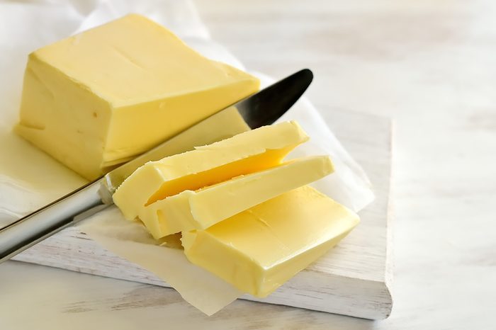 knife slicing butter on a white board
