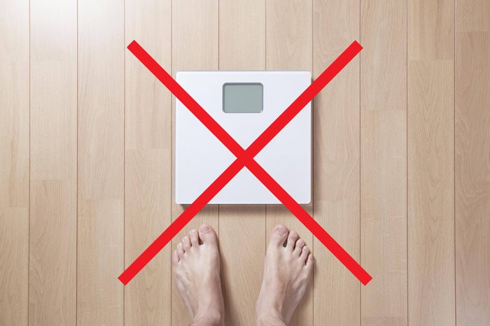 Person stepping on a scale with an X through it.