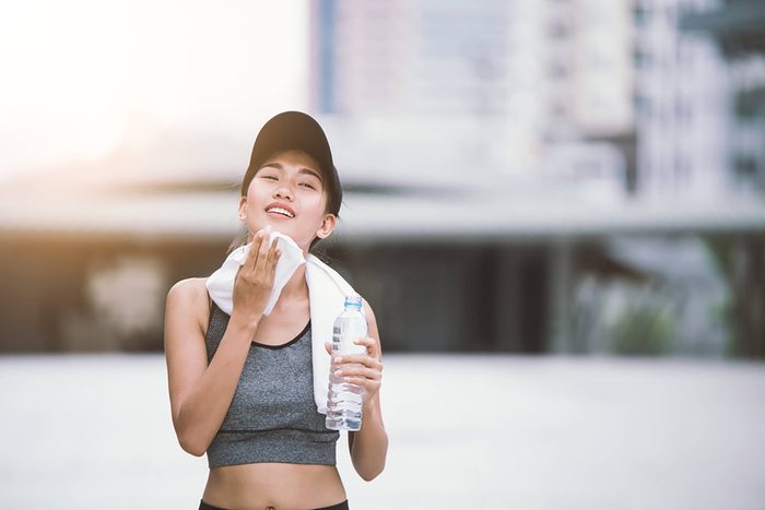 woman drinking after exercising