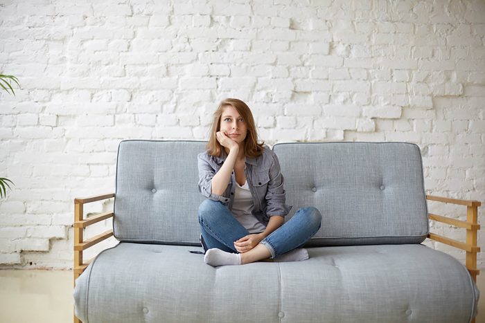 inactive woman sitting on couch