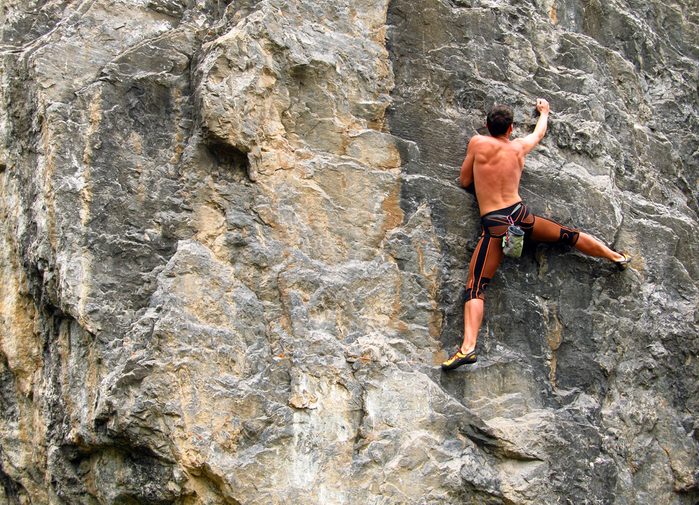 person rockclimbing