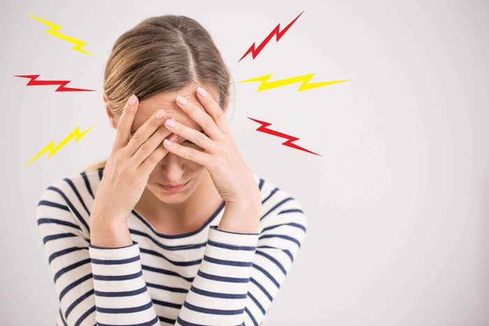 woman with throbbing migraine headache