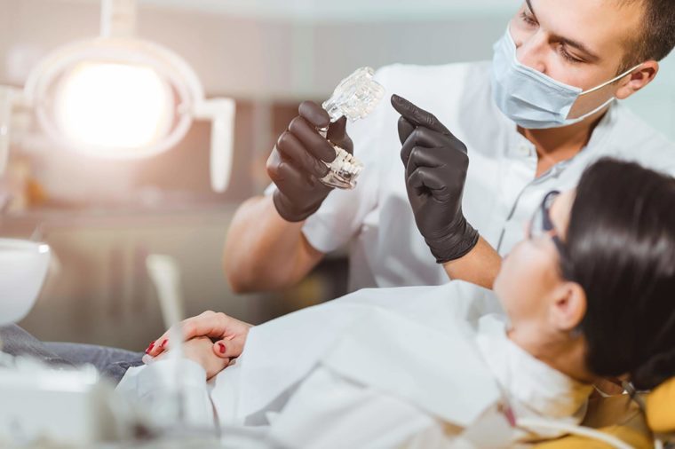 Dentist explaining device to patient