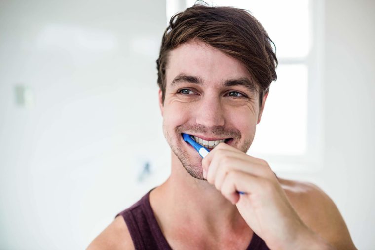 man smiling and Brushing teeth