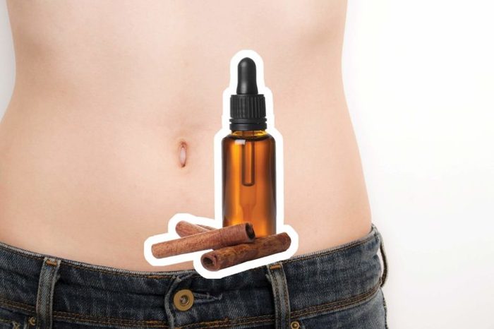 Cinnamon oil over a woman's bare abdomen