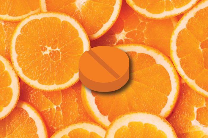 Illustration of a vitamin C tablet on an orange slice background.