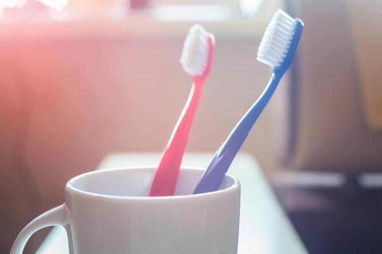 Toothbrushes in a coffee cup