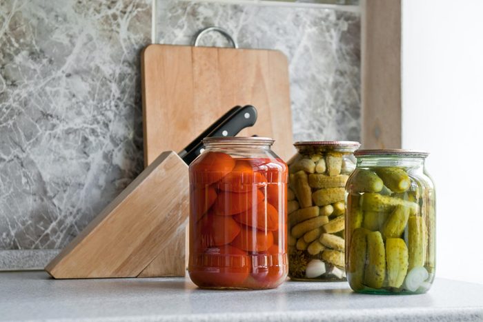 jars of pickled vegetables on a kitchen counter