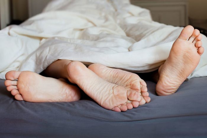 Lover's feet in the bed