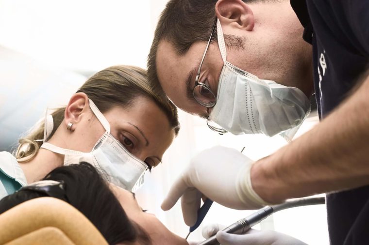 dentist and assistant working on a sedated patient