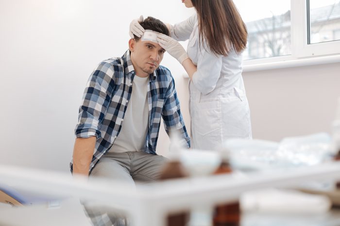 doctor evaluating patient head injury