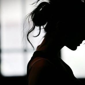 Silhouette of woman's head with waving hair, back light.