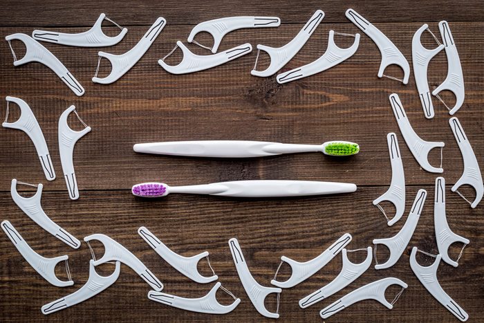assortment of dental floss picks and toothbrushes