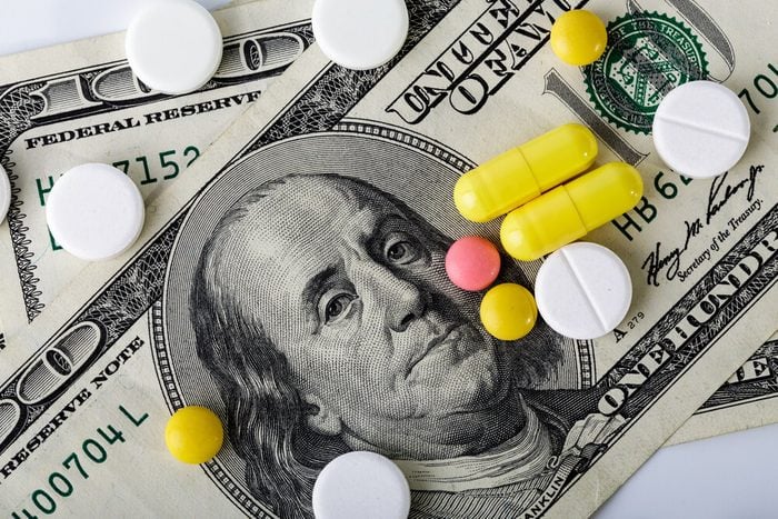 Medicine pills or capsules, vitamin with money, dollar. Medical or pharmacy prescription for health. Business, finance concept. Cost of the healthy life. Money and pharmacy still life