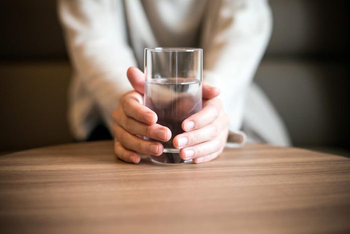 Woman holding a glass of the water