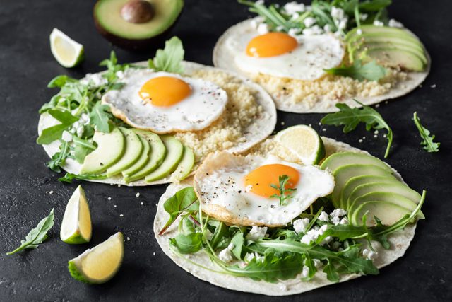 healthy breakfast tacos with eggs and avocados and greens