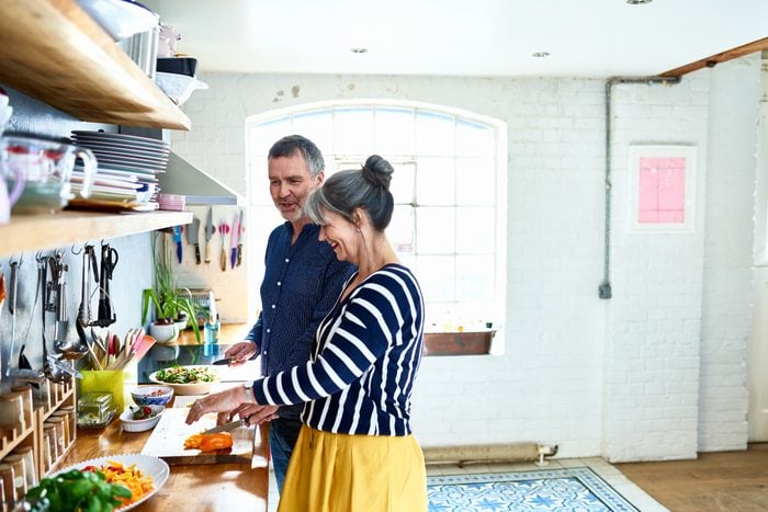 mature couple preparing food together in the kitchen