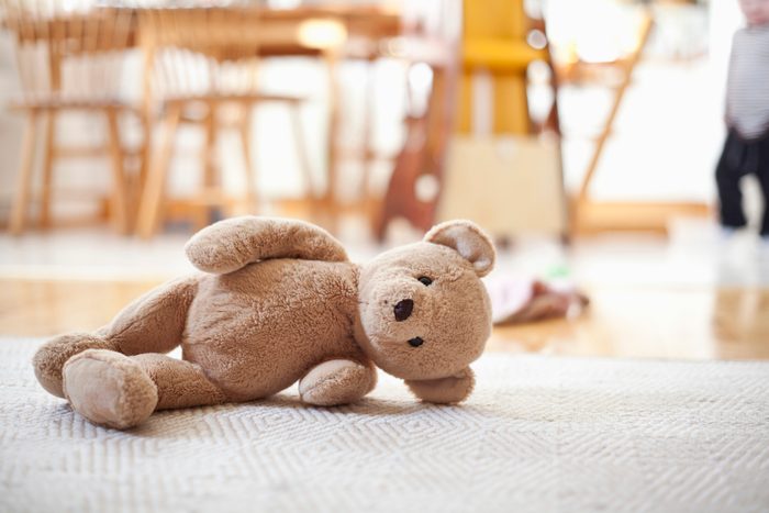 stuffed teddy bear toy on ground of home