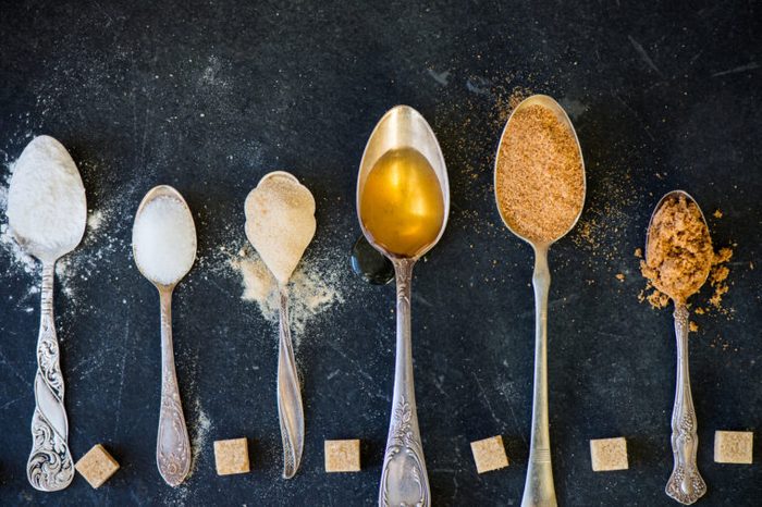 different kinds of sugars in spoons overhead