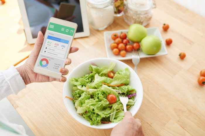 woman counting calories on diet app
