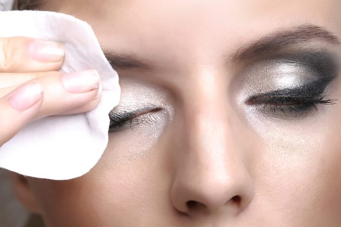Removing makeup with cotton pad