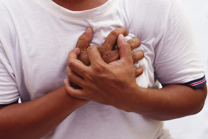 Man squeezing chest pain