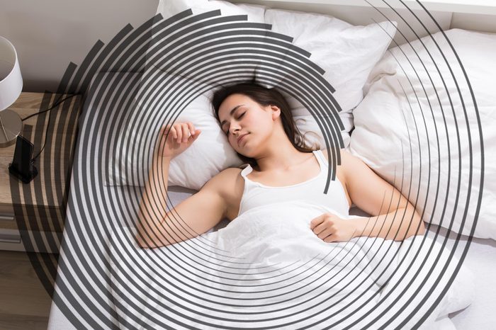 woman on her back in bed, sleeping peacefully