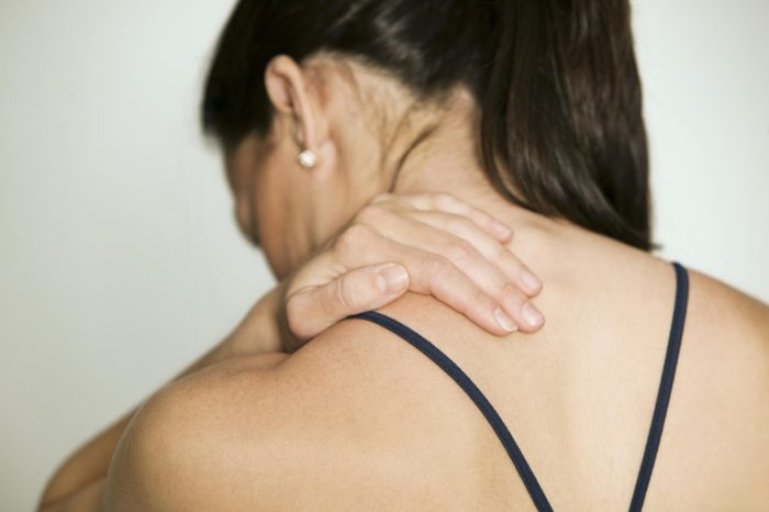 Woman massaging shoulder