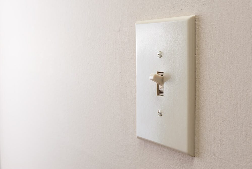 Classic light switch hanging on the wall