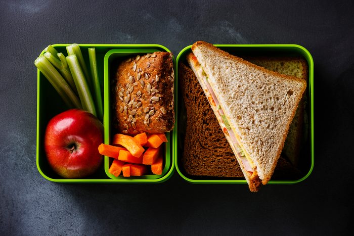 Take out food Lunch box with Sandwiches and vegetables on blackboard background