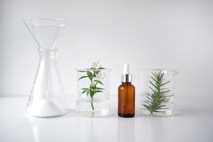 amber spray bottle and jars with herbs