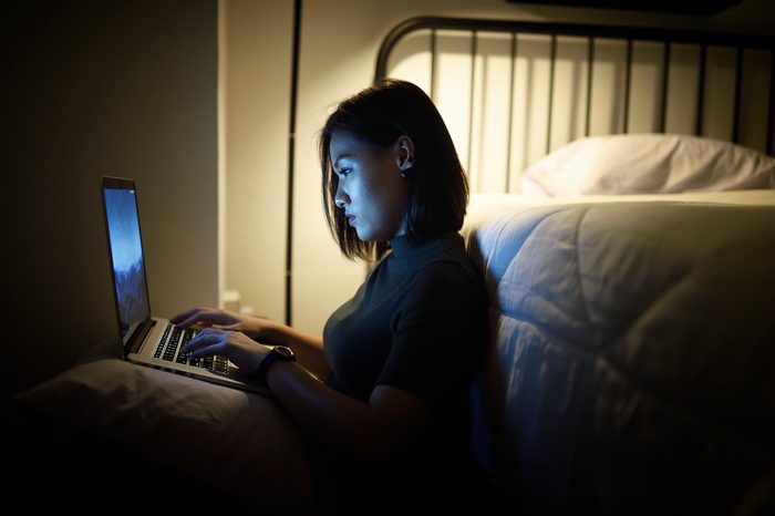 woman using laptop at night