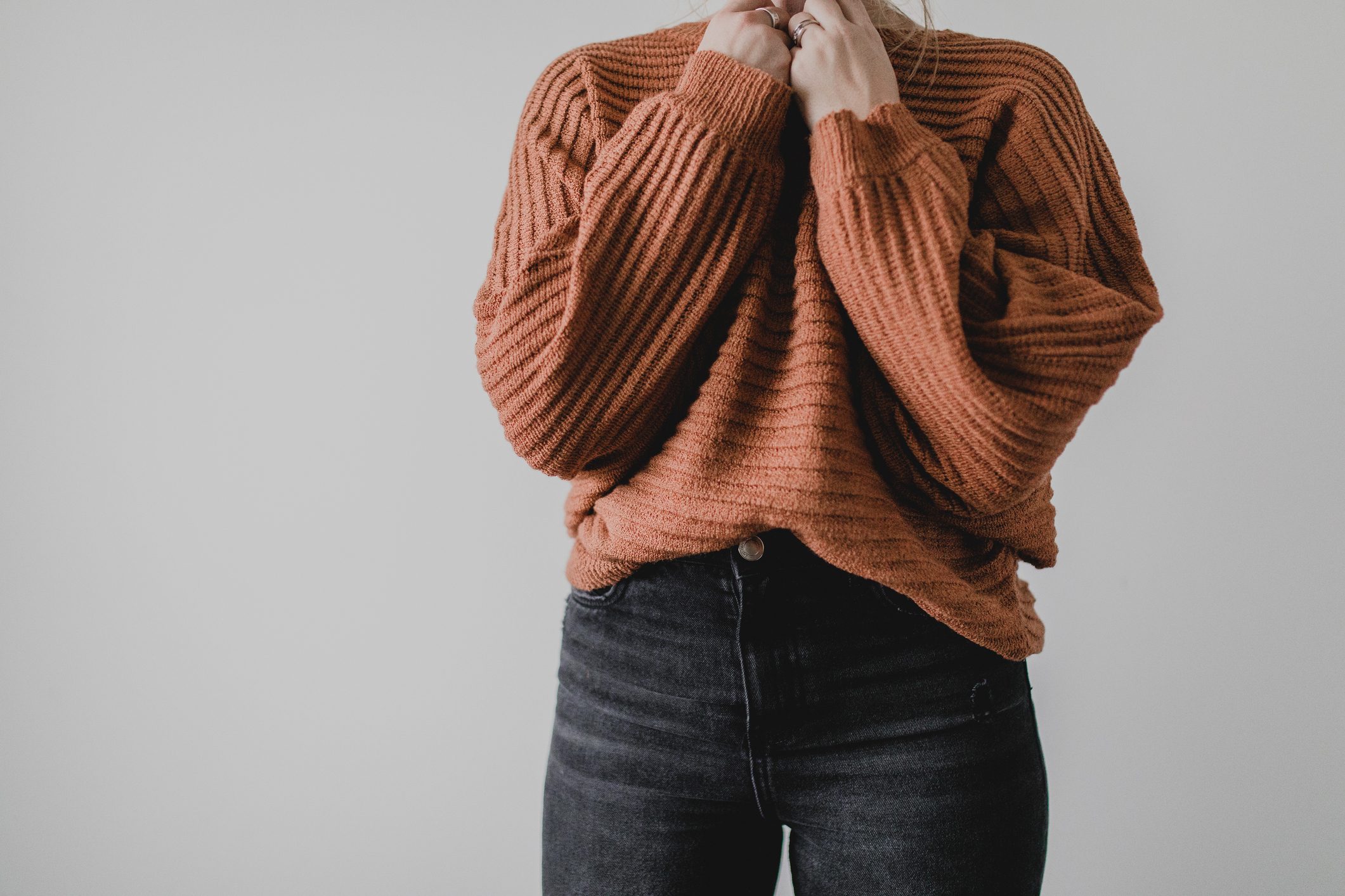 cropped shot of woman's outfit sweater and jeans