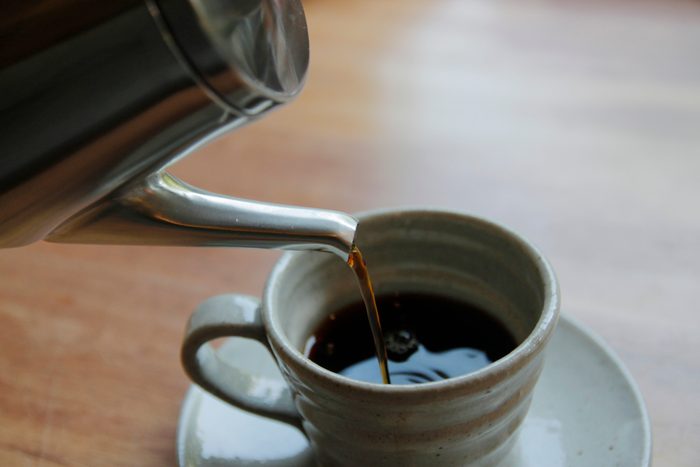 close up of coffee being poured into cup
