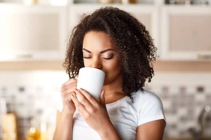 Woman sipping out of a mug